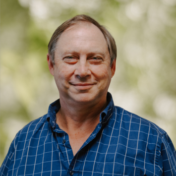 Photograph of Dr Peter Rallings. He is smiling warmly at the viewer.